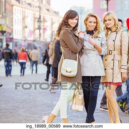 Three cheerful female friends in the old town View Large Photo Image Stock Photo - Three cheerful female friends in the old town. Fotosearch