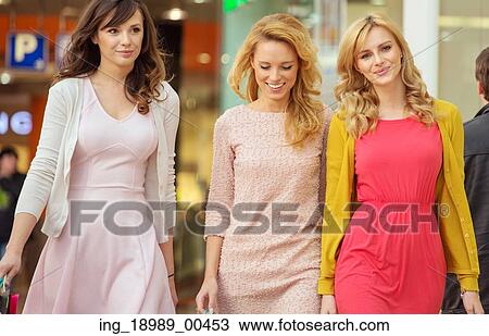 Three cheerful ladies in the shopping mall View Large Photo Image Stock Image - Three cheerful ladies in the shopping mall. Fotosearch