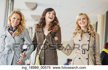 Three cheerful ladies walking during the warm spring day View Large Photo Image Stock Photography - Three cheerful ladies walking during the warm spring day. Fotosearch