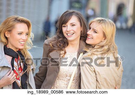 Three young beautiful women smiling View Large Photo Image Stock Photograph - Three young beautiful women smiling. Fotosearch