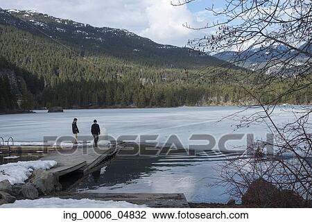 Tourists standing on a dock at the lakeside, Whistler, British Columbia, Canada View Large Photo Image Stock Image - Tourists standing on a dock at the lakeside, Whistler, British Columbia, Canada. Fotosearch