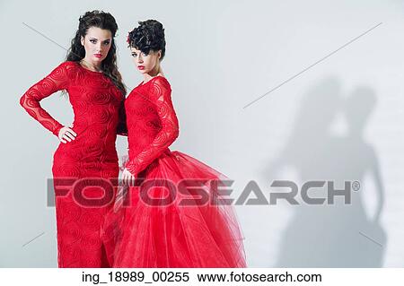 Two adorable brunette girlfriends wearing red dresses View Large Photo Image Stock Photography - Two adorable brunette girlfriends wearing red dresses. Fotosearch