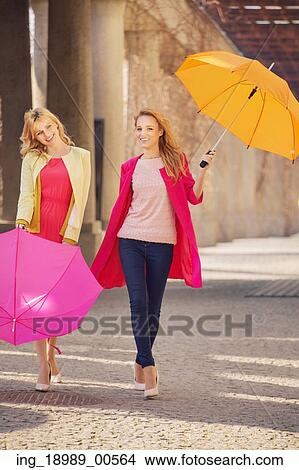 Two attractive girlfreinds with the colorful umbrellas View Large Photo Image Picture - Two attractive girlfreinds with the colorful umbrellas. Fotosearch