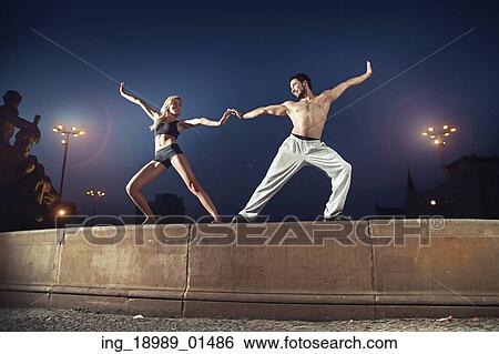 Two cheerful athletes practising in the night View Large Photo Image Stock Photograph - Two cheerful athletes practising in the night. Fotosearch