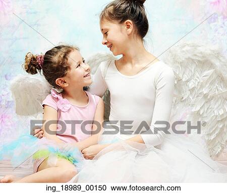 Stock Image - Two cute sisters enjoying their company. Fotosearch