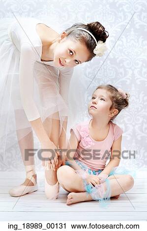 Stock Image - Two cute sisters practising ballet dance. Fotosearch