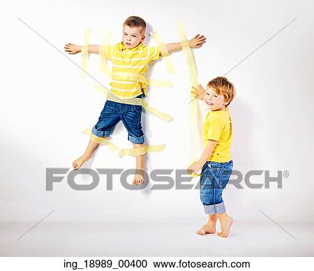 Stock Image - Two cute smiling brothers playing together. Fotosearch