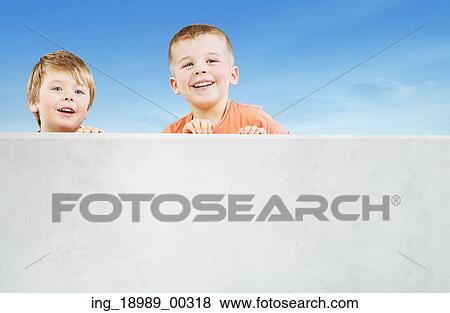 Stock Photo - Two smiling boys staring at something interesting. Fotosearch
