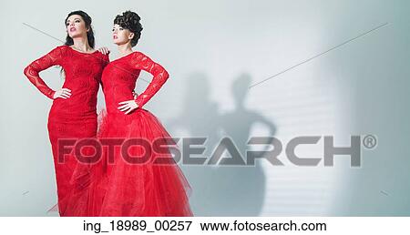 Stock Photo - Two young sexy sisters in glamour pose. Fotosearch