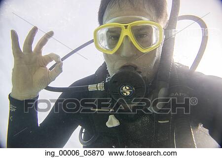 Stock Image - Underwater view of a scuba diver gesturing, Ixtapa, Guerrero, Mexico. Fotosearch