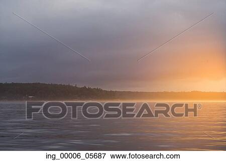 View of a lake at sunset, Lake Of The Woods, Ontario, Canada View Large Photo Image Stock Photo - View of a lake at sunset, Lake Of The Woods, Ontario, Canada. Fotosearch
