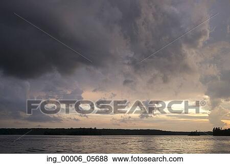 View of a lake at sunset, Lake Of The Woods, Ontario, Canada View Large Photo Image Stock Photo - View of a lake at sunset, Lake Of The Woods, Ontario, Canada. Fotosearch