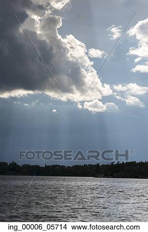 Picture - View of clouds over a lake, Lake of the Woods, Ontario, Canada. Fotosearch