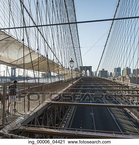 Stock Image - View of the Brooklyn Bridge with buildings in the background, Manhattan, New York City, New York State, USA. Fotosearch