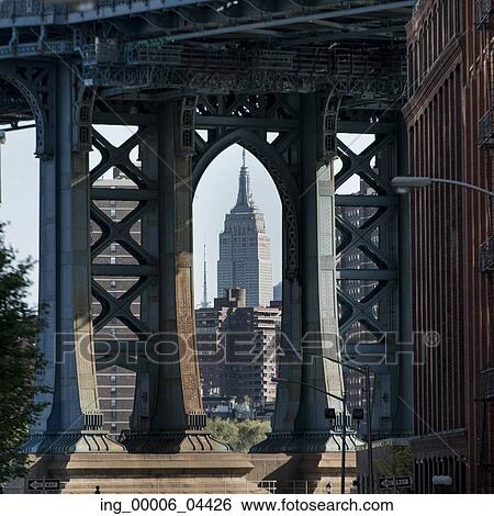Stock Photograph - View of the Empire State Building through Manhattan Bridge, Manhattan, New York City, New York State, USA. Fotosearch