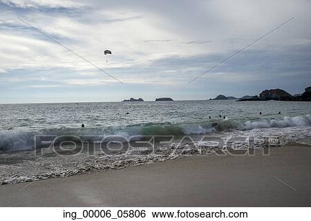 View of tourists in the ocean, enjoying the beach, Ixtapa, Guerrero, Mexico View Large Photo Image Stock Photograph - View of tourists in the ocean, enjoying the beach, Ixtapa, Guerrero, Mexico. Fotosearch