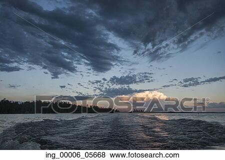 Wake in the lake at dusk, Lake Of The Woods, Ontario, Canada View Large Photo Image Stock Photo - Wake in the lake at dusk, Lake Of The Woods, Ontario, Canada. Fotosearch