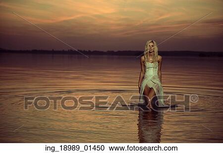 Stock Image - Water nymph walking in the river. Fotosearch