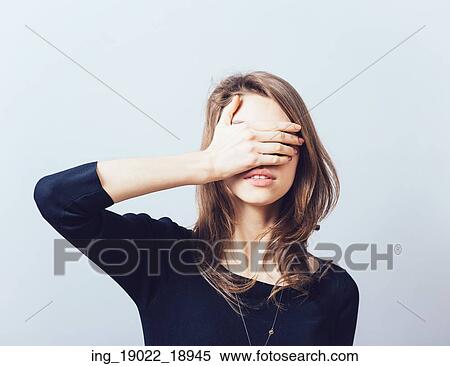 woman covering her eyes isolated on a gray background View Large Photo Image Stock Photography - woman covering her eyes isolated on a gray background. Fotosearch