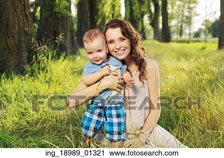 Woman hugging her similing little son View Large Photo Image Stock Image - Woman hugging her similing little son. Fotosearch