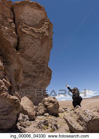 Woman pointing at Pakana Monk, Salar de Atacama, San Pedro de Atacama, El Loa Province, Antofagasta Region, Chile View Large Photo Image Stock Image - Woman pointing at Pakana Monk, Salar de Atacama, San Pedro de Atacama, El Loa Province, Antofagasta Region, Chile. Fotosearch