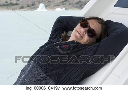 Woman relaxing at Lake Argentino, Santa Cruz Province, Patagonia, Argentina View Large Photo Image Stock Photo - Woman relaxing at Lake Argentino, Santa Cruz Province, Patagonia, Argentina. Fotosearch
