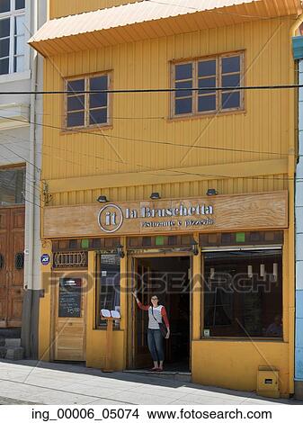 Picture - Woman standing at doorway of a restaurant, Valparaiso, Chile. Fotosearch