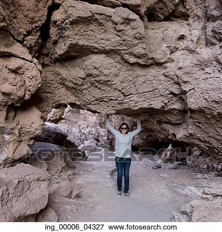 Woman standing under a rock formation, Valle de la Luna, San Pedro de Atacama, El Loa Province, Antofagasta Region, Chile View Large Photo Image Stock Photo - Woman standing under a rock formation, Valle de la Luna, San Pedro de Atacama, El Loa Province, Antofagasta Region, Chile. Fotosearch