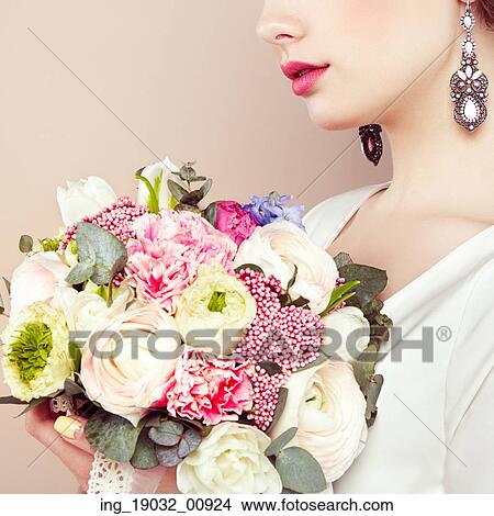 Picture - Woman with bouquet of flowers in her hands. Flowers. Spring. Bride. March 8. Fashion photo. Fotosearch