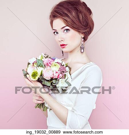 Woman with bouquet of flowers in her hands. Flowers. Spring. Bride. March 8. Fashion photo View Large Photo Image Stock Photo - Woman with bouquet of flowers in her hands. Flowers. Spring. Bride. March 8. Fashion photo. Fotosearch