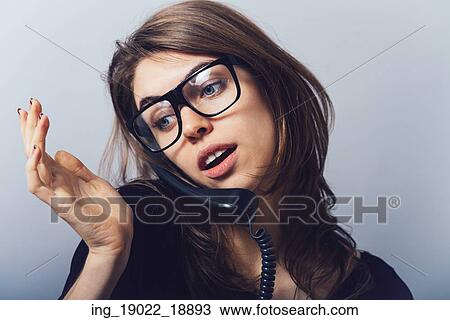 Woman with office or home phone. On a gray background. View Large Photo Image Stock Image - Woman with office or home phone. On a gray background.. Fotosearch
