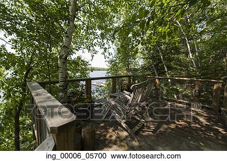Wooden lounge chairs on a deck, Lake of the Woods, Ontario, Canada View Large Photo Image Stock Image - Wooden lounge chairs on a deck, Lake of the Woods, Ontario, Canada. Fotosearch