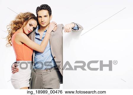Stock Photograph - Young adorable couple promoting sales. Fotosearch