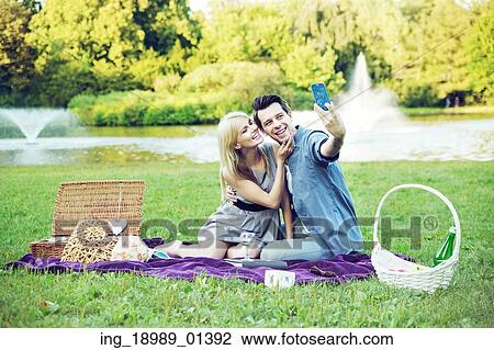 Young cheerful couple making the self portrait View Large Photo Image Stock Image - Young cheerful couple making the self portrait. Fotosearch