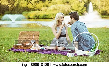 Young couple on the summer picnic View Large Photo Image Stock Image - Young couple on the summer picnic. Fotosearch
