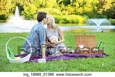 Young couple on the very romantic date in the park View Large Photo Image Stock Photograph - Young couple on the very romantic date in the park. Fotosearch