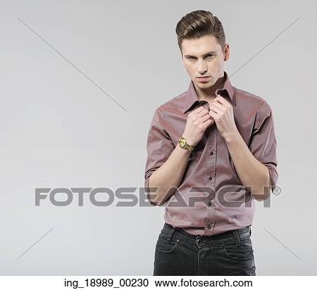Stock Image - Young handsome guy with classic haircut. Fotosearch