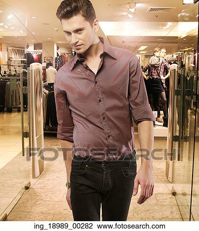 Young man in the popular boutique View Large Photo Image Stock Image - Young man in the popular boutique. Fotosearch