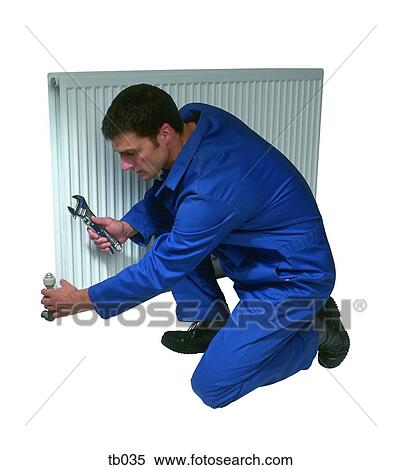 Photograph of a man fixing a domestic radiator View Large Photo Image Stock Photography - Photograph of a man fixing a domestic radiator. Fotosearch
