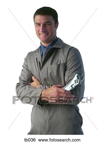 Stock Photograph - Photograph of a non-specific tradesman holding an adjustable wrench. Fotosearch