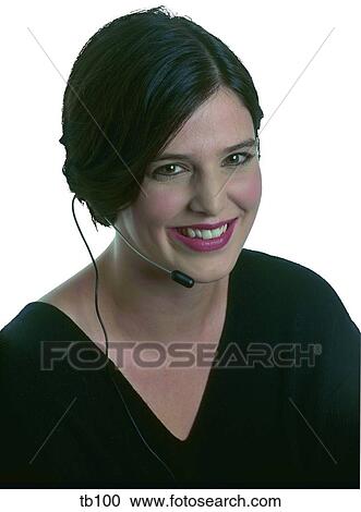 Stock Image - Photograph of a woman wearing telephonists earpiece. Fotosearch