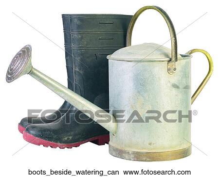 Boots beside watering can View Large Photo Image Picture - Boots beside watering can. Fotosearch