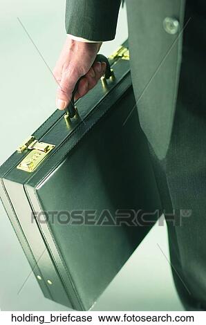 Holding briefcase View Large Photo Image Stock Image - Holding briefcase. Fotosearch