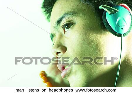 Man listens on headphones View Large Photo Image Stock Photograph - Man listens on headphones. Fotosearch