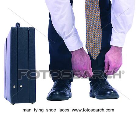 Man tying shoe laces View Large Photo Image Stock Photograph - Man tying shoe laces. Fotosearch