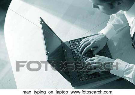 Stock Photography - Man typing on laptop. Fotosearch