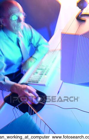 Man working at computer View Large Photo Image Stock Photography - Man working at computer. Fotosearch