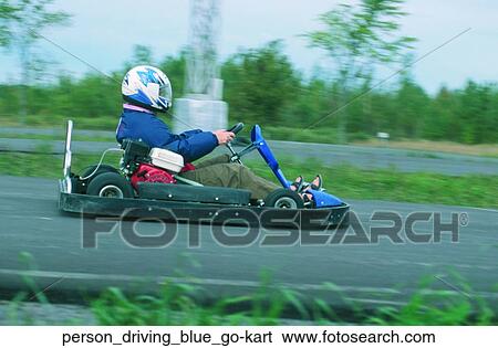 Stock Photograph - Person driving blue go-kart. Fotosearch