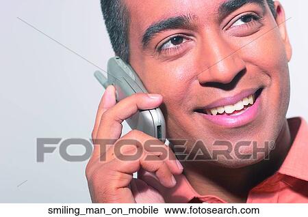 Smiling man on mobile View Large Photo Image Stock Image - Smiling man on mobile. Fotosearch