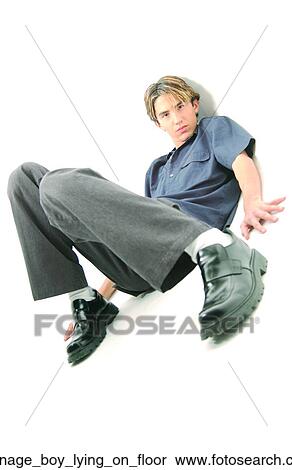 Stock Photography - Teenage boy lying on floor. Fotosearch